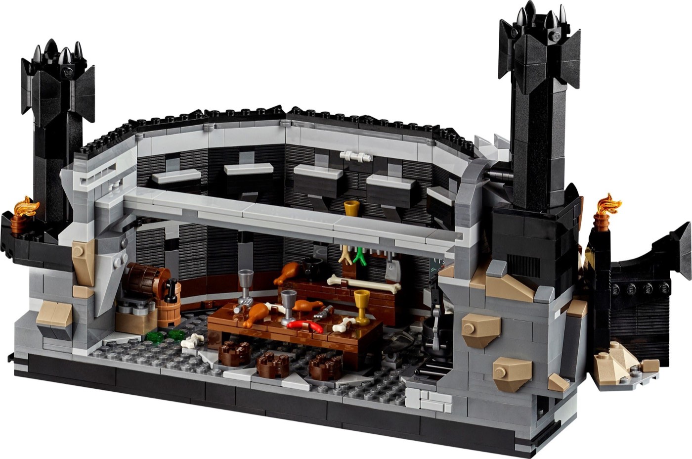 Orc cafeteria level inside the LEGO Barad-dûr 10333, with a laden table, barrels and torches set into the black brick walls