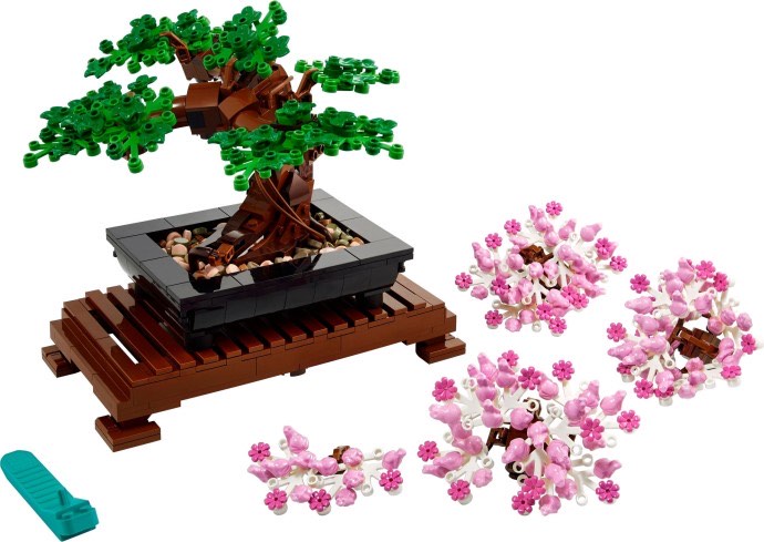 LEGO Bonsai Tree 10281 built with green foliage beside its separate pink cherry blossom clusters