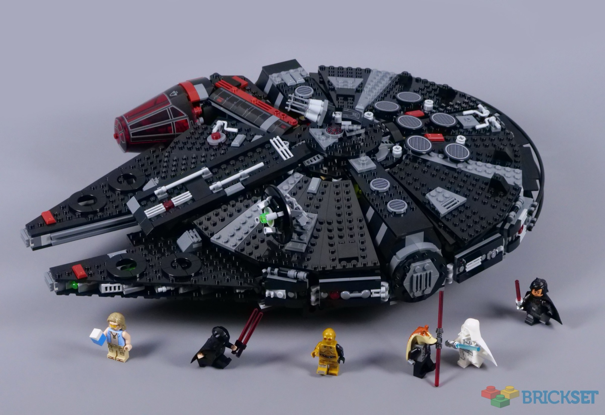 LEGO Dark Falcon 75389 displayed with all six alternate-universe minifigures in front of the black and red starship