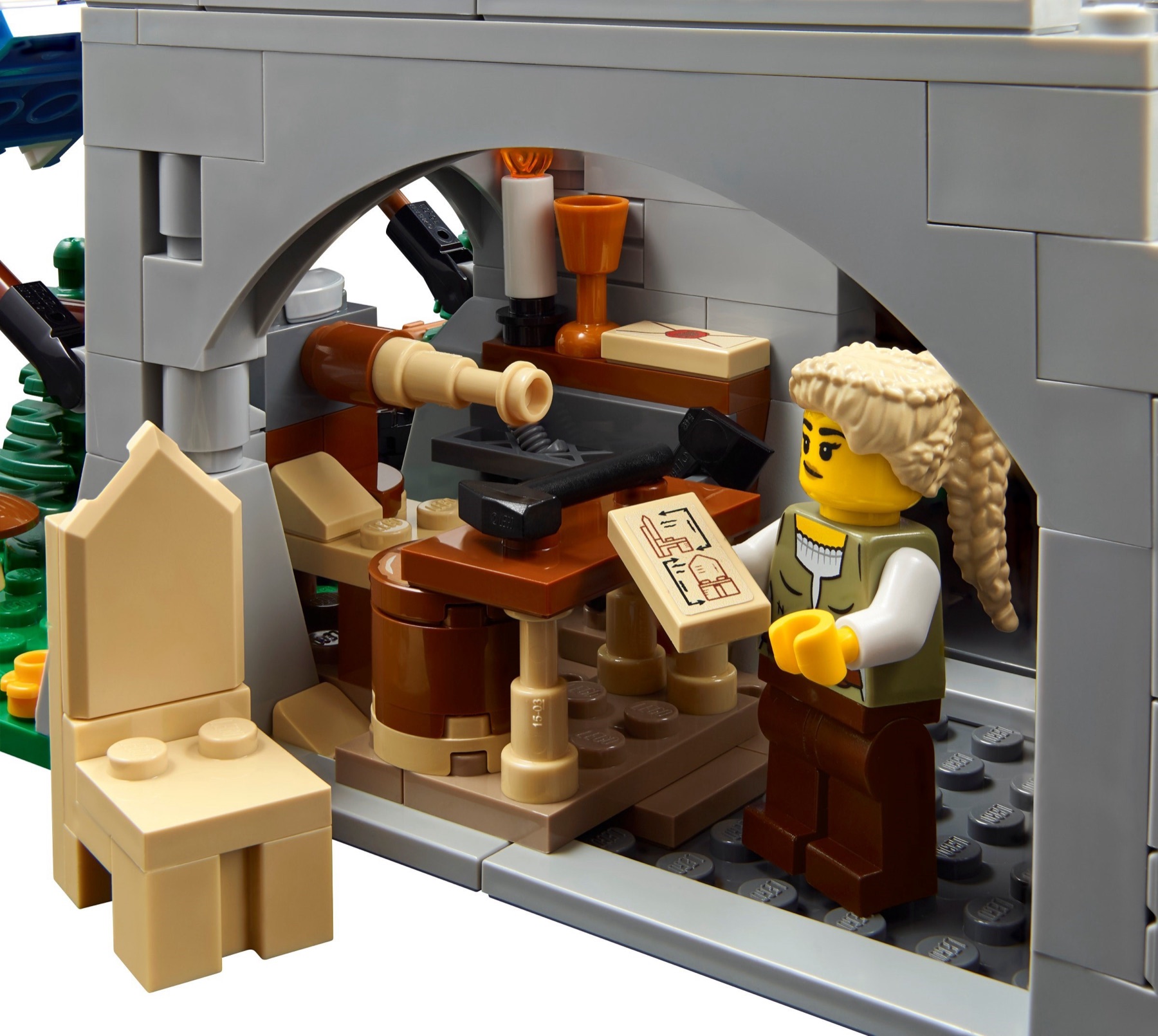 Shieldsmith workshop inside LEGO Medieval Town Square 10332 with tools, plans, a chair and a minifigure craftsperson