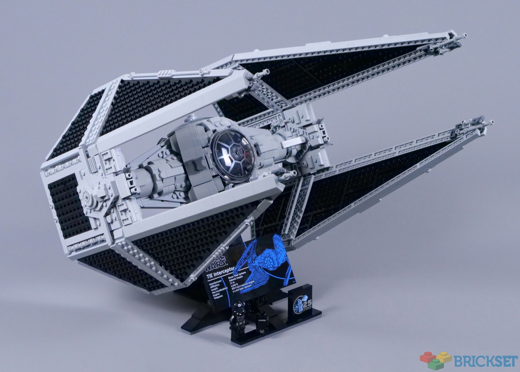LEGO UCS TIE Interceptor 75382 displayed on its angled stand with the information plaque and TIE Pilot
