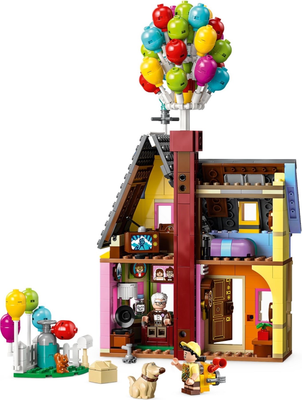 Built LEGO 'Up' House 43217 with its cluster of coloured balloons above the roof, the open interior rooms and Carl, Russell and Dug below