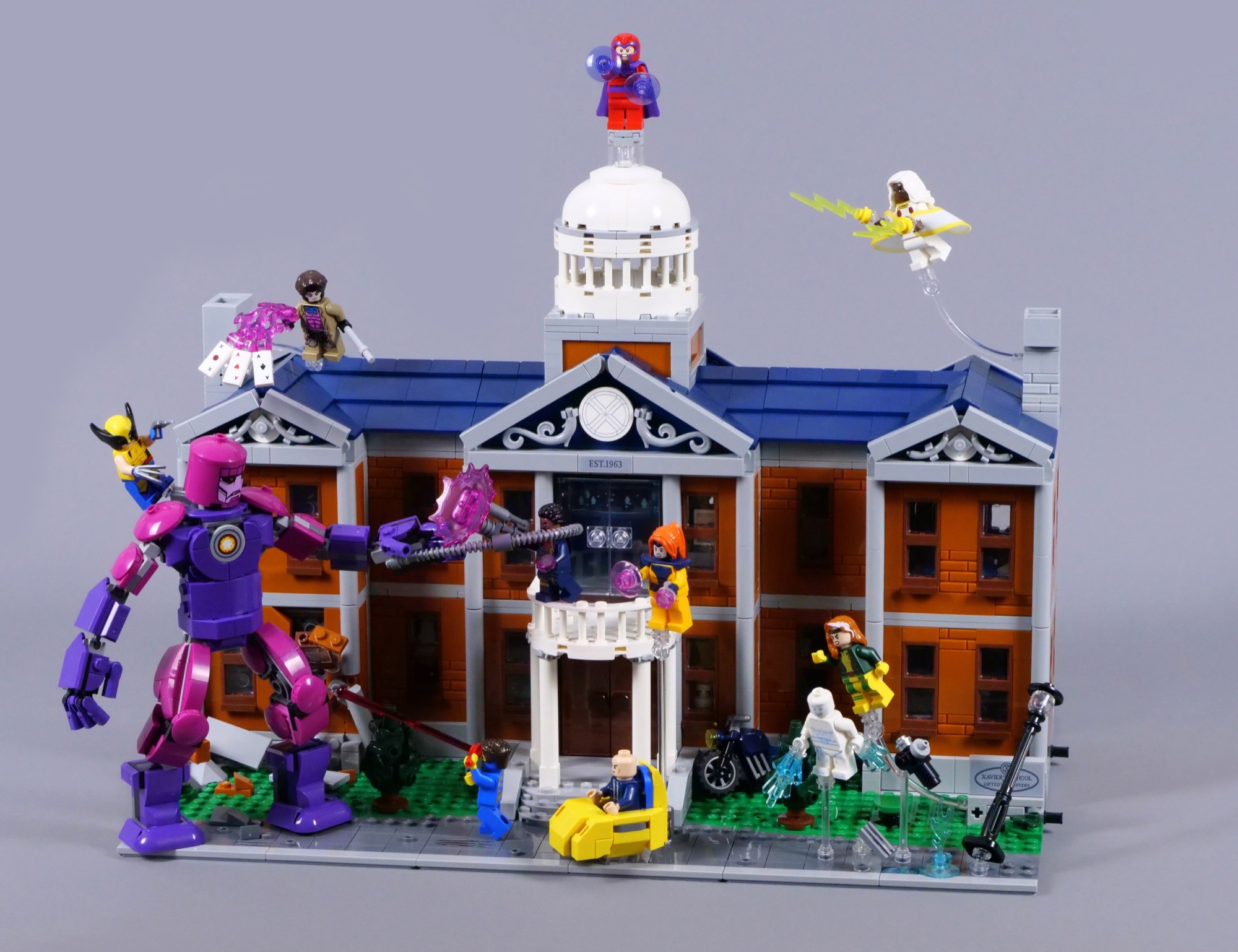 LEGO X-Mansion 76294 displayed with the Sentinel and X-Men minifigures across the front lawn