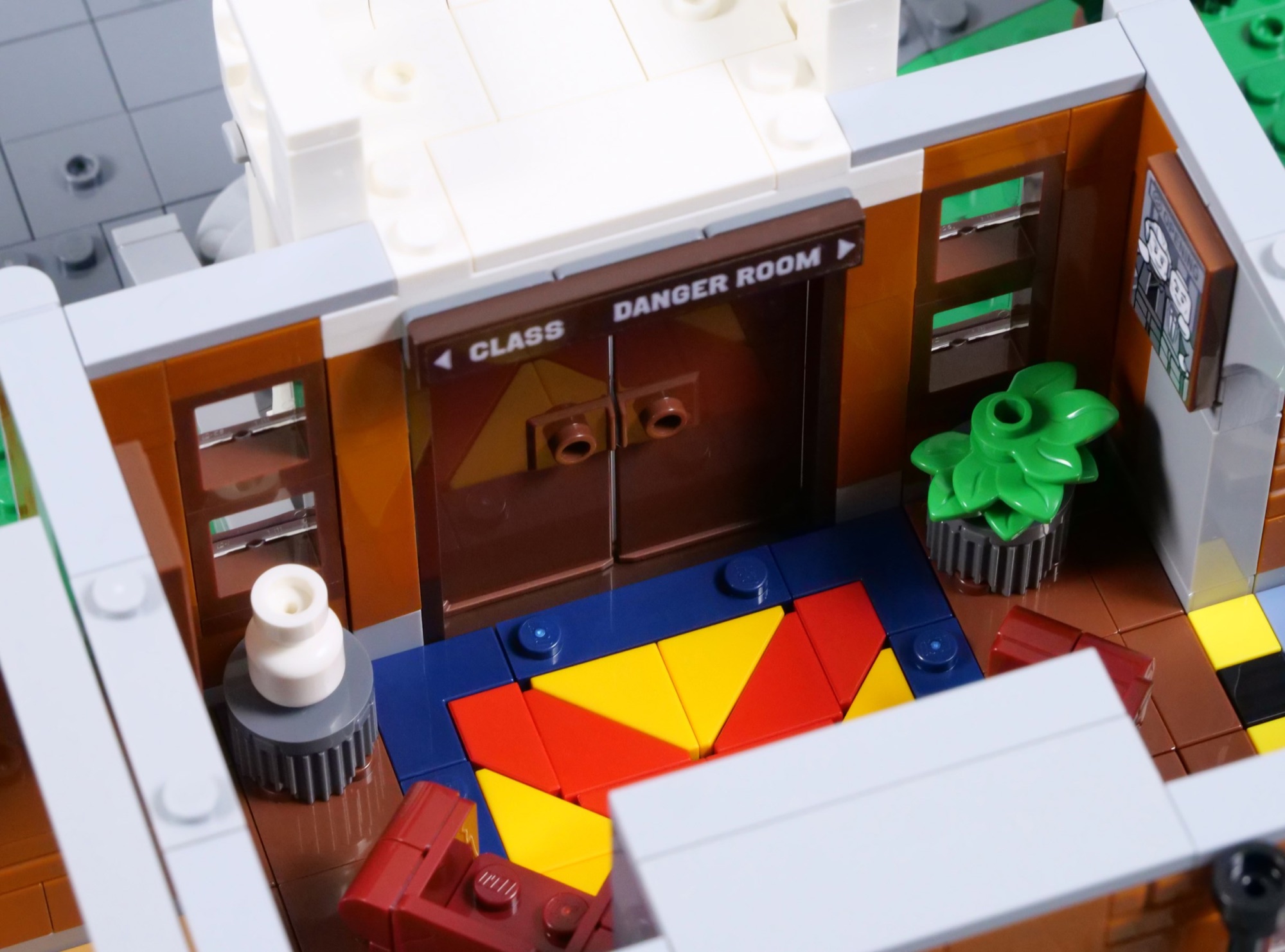 Interior entrance hall of LEGO X-Mansion 76294 with the staircase and opening doors to the Danger Room